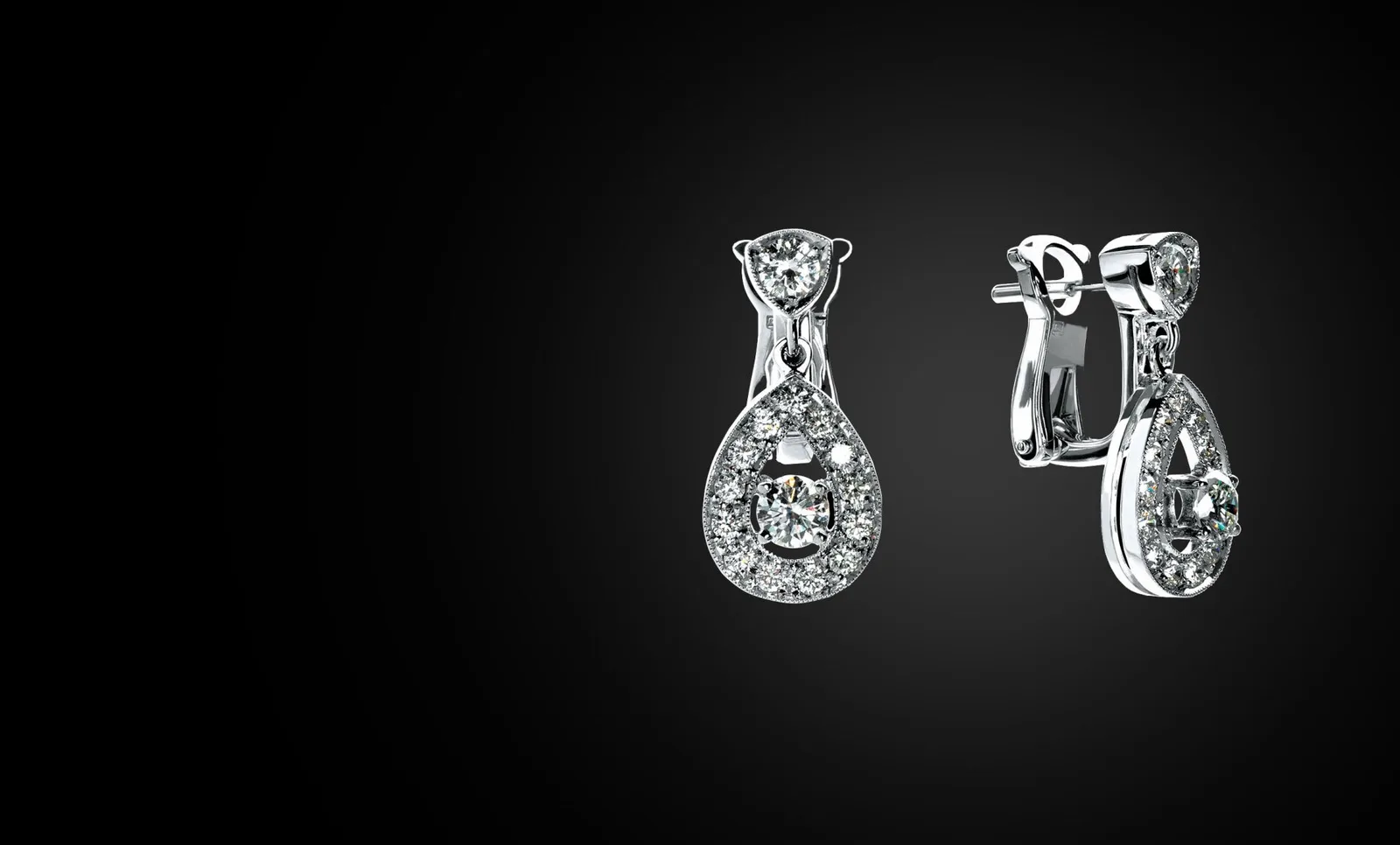 A pair of diamond drop earrings on black